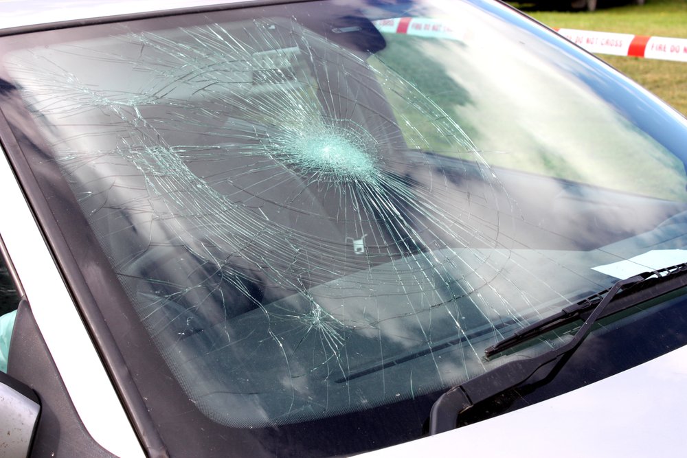 A Broken Car windshield at an Accident Site.
