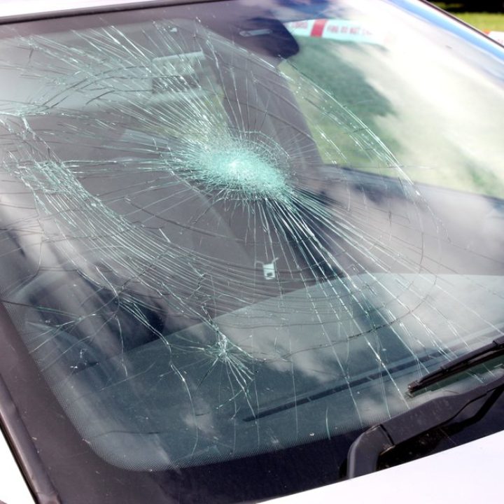 A Broken Car windshield at an Accident Site.